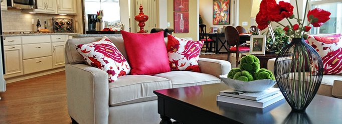 An open-concept living room with a view into the kitchen.