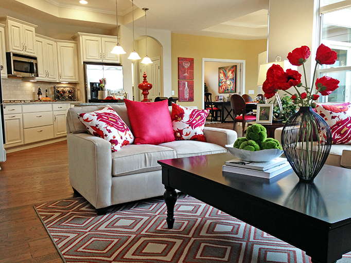 An open-concept living room with a view into the kitchen.