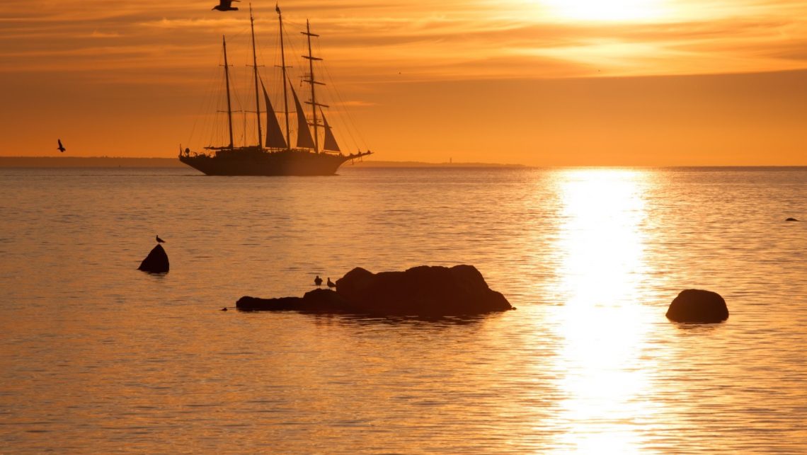 Epcon Franchise - Sail boat sailing under an orange sunset