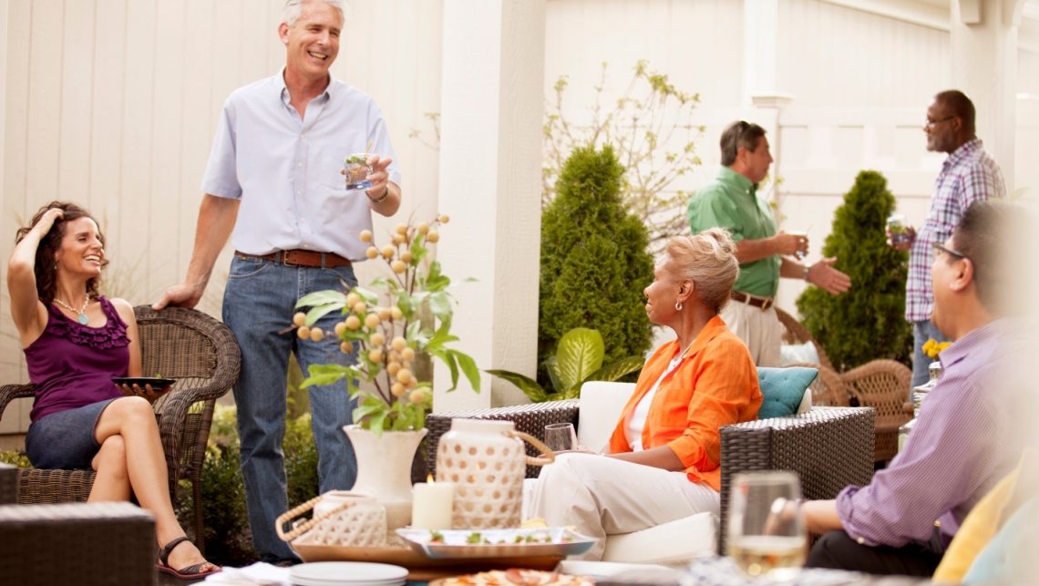 6 people socializing on a Epcon Communities home patio